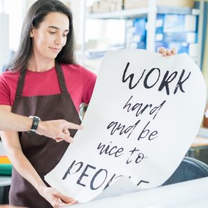 Coworking colleagues with printed poster